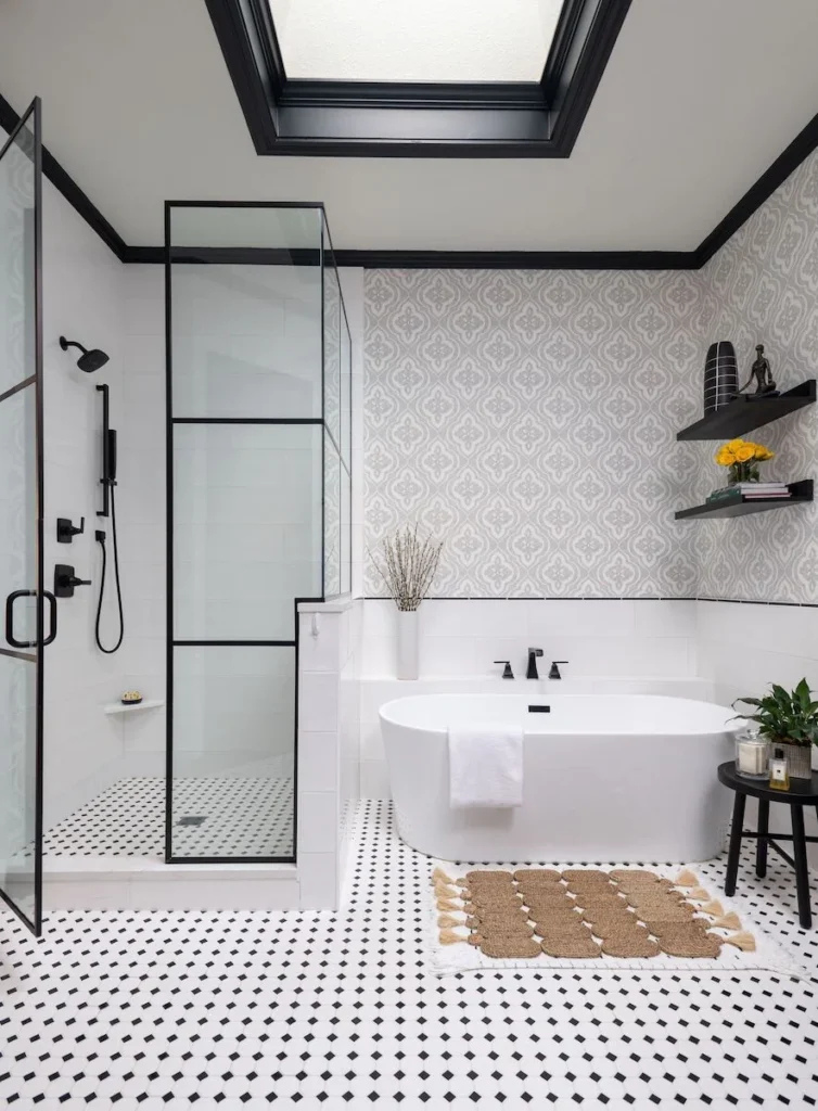 Modern bathroom remodel featuring a glass-enclosed shower, a sleek vanity with a large mirror, and bright lighting by Sunshine Sunrooms