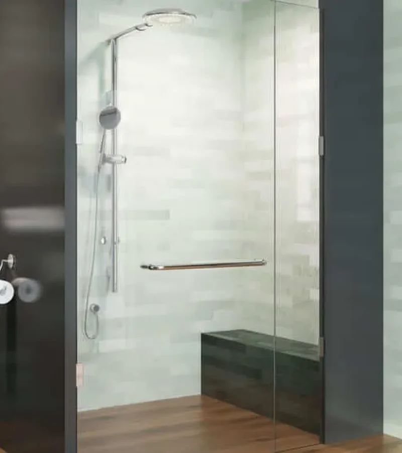 Minimalist style, with dark greens and wood accents against light green shower walls of walk-in, glass front shower. Chrome faucets and hardware.