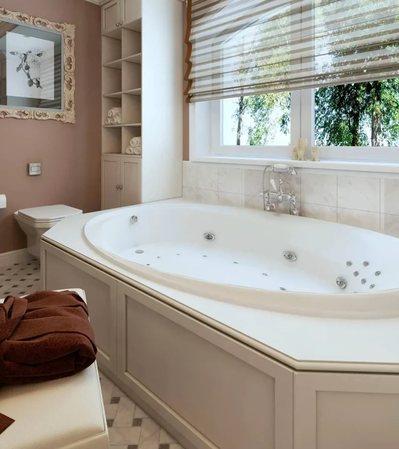 Close up of large built-in soaker tub with jets. Earth tones used throughout, full height storage cabinet and glass corner shower make great use of the space.